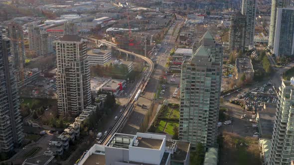 Vancouver Skytrain Moving Past Brentwood Station In Burnaby Canada- aerial shot