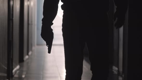 Silhouette of Man Going with Handgun