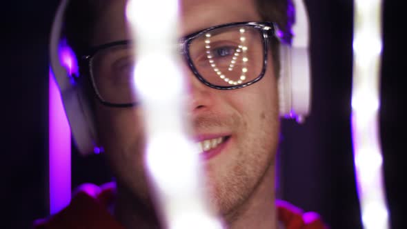Man in Headphones Over Neon Lights of Night Club 38