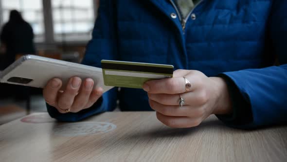 Female Hands Pay Online Ordering Lunch Via Phone Using Credit Card