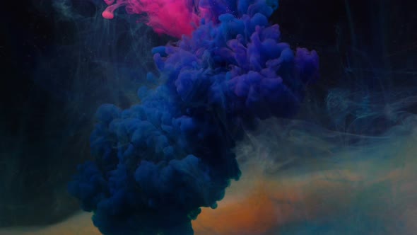 Neon Pink and Blue Ink Clouds Mix Among Peachy Smoke