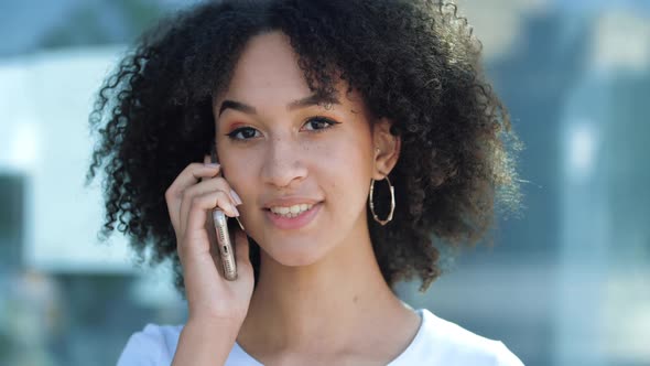 Beautiful African American Teen Girl Talking on Phone, Making an Appointment, Waiting for Friends