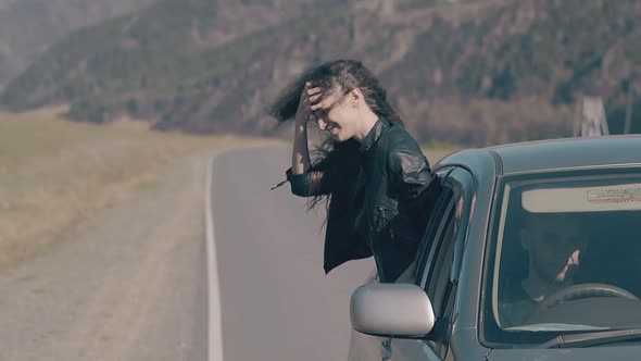 Fabulous Slim Woman Leans Out of Car Window and Dances