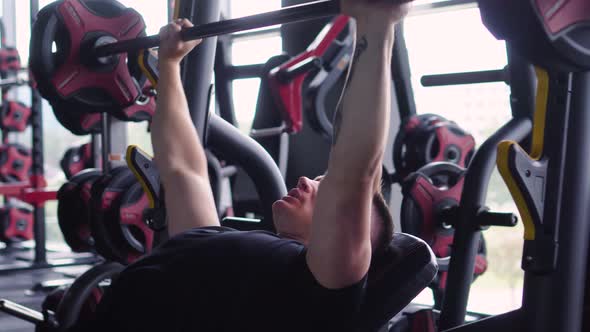 Muscular Man is Engaged in the Gym