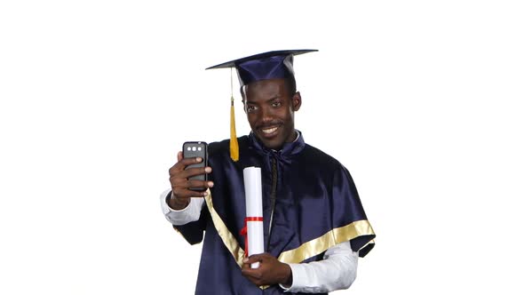 Graduate Takes a Photo with a Diploma