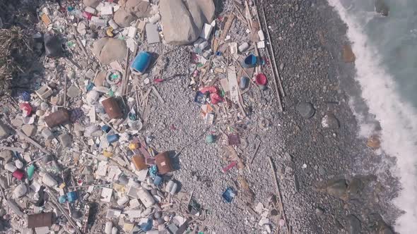 Environmental issues shown by beach covered in plastic and rubbish in Hong Kong. Static aerial drone