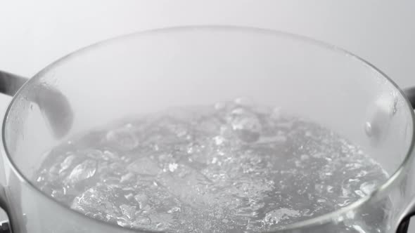 Camera follows cooking green beans in boiling water. Slow Motion. alt