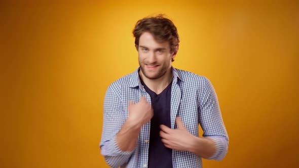Confused Young Man Gesturing "It's Not Me It's Not My Fault" Yellow Background