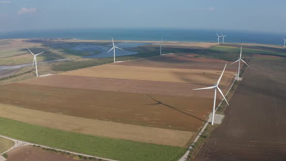 Aerial Shot of Wind Generators Among Arable Land