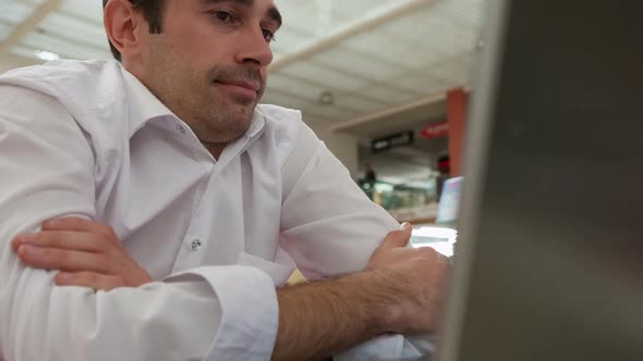 A Young Man Talking Using a Web Camera and Smiling