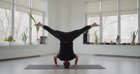 Professional Trainer Practices Flow Yoga in Private Class