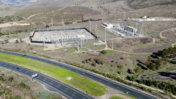 High Voltage Power Electric Station with Dry Mountain Background