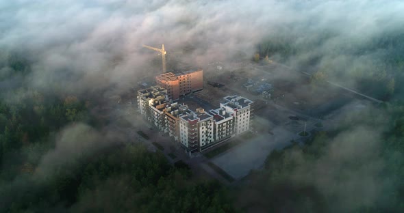 Top view through the fog on the construction of a residential complex