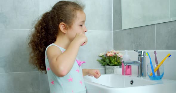 Portrait Happy Cute Young Teenage Girl Brushing Teeth in Bathroom and Smiling