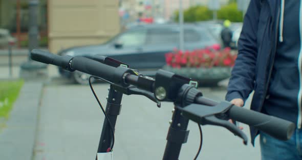 Tourist Man Take Electric Kick Scooter in Sharing Parking Lot, Tourist Phone Application. New