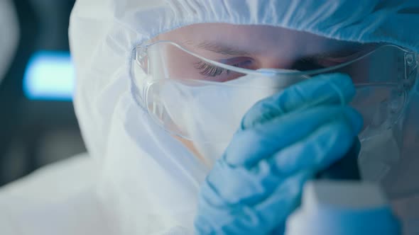 Virologist or Scientist is Looking Into Microscope alt