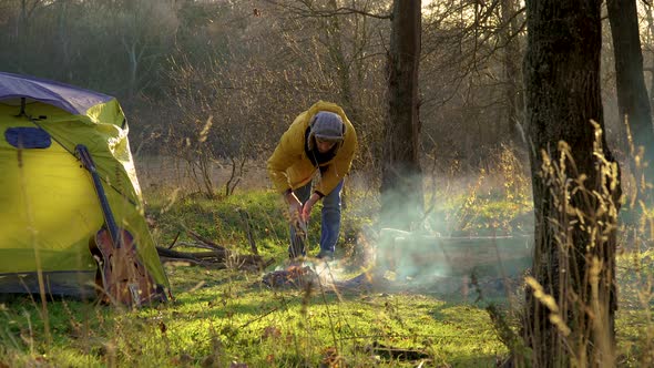 Tourist Breaks Wood and Lights Fire