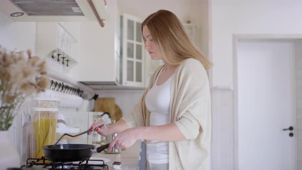 Woman Making Pancakes in Morning