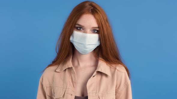 Redhaired Model in Medical Mask and Beige Jacket