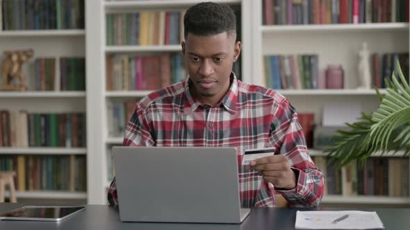 African Man making Successful Online Payment on Laptop