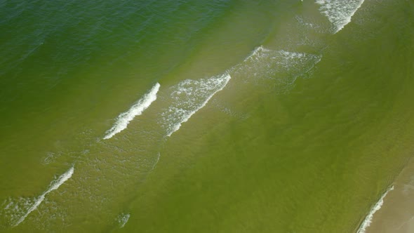 Look down on empty Beach in Osetnik, Poland, early autumn 2020, Drone Slowly flying backward, pointi