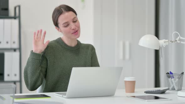 Young Woman Talking on Video Chat on Laptop 