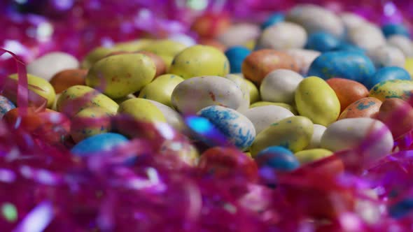 Rotating shot of colorful Easter candies on a bed of easter grass 