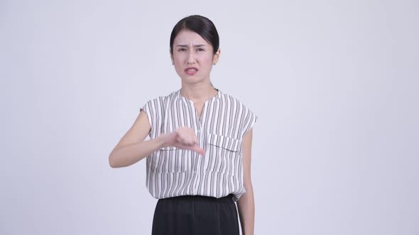 Angry Asian Businesswoman Giving Thumbs Down