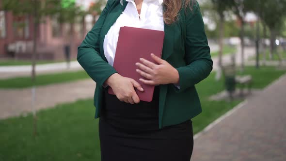 Unrecognizable Nervous Worried Plussize Caucasian Woman Standing on City Street with Laptop Waiting