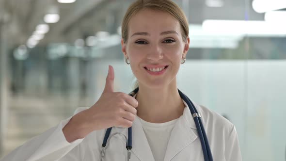 Portrait of Positive Female Doctor Doing Thumbs Up 