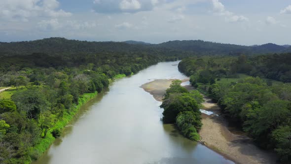 Aerial Drone View of Rainforest River and Mountains Scenery in Costa Rica at Boca Tapada, San Carlos