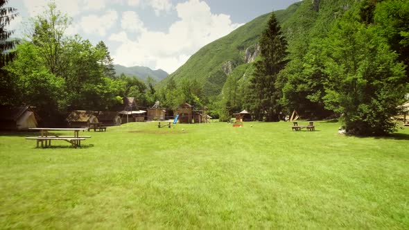 Aerial view of a summer camp with cabins and recreational area in the forest.