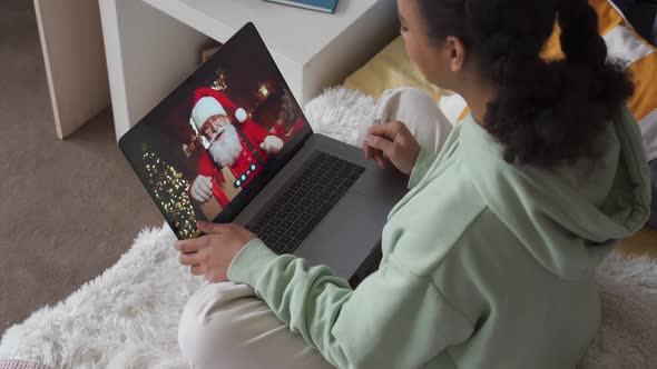 African American Teen Girl Talking To Virtual Santa on Video Chat Online Call