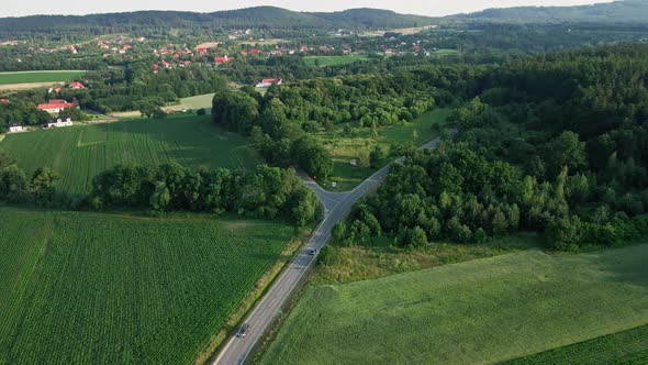 Car Moving on Road Through Mountains Aerial View