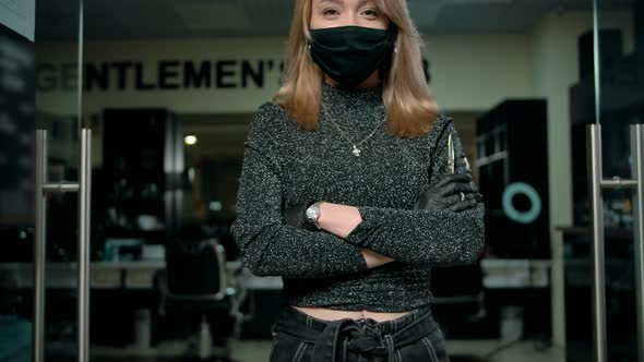 Young Woman Barber in Protective Mask Walking Inside of Modern Barbershop