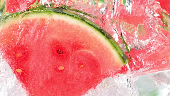 Super Slow Motion Shot of Pouring Water on Melon Slices and Ice Cubes in Glass at 1000 Fps