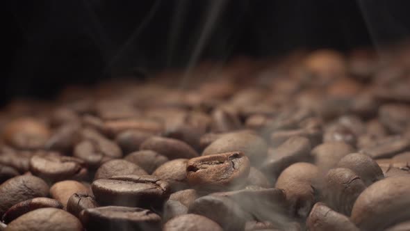 Nice and Cinematic Footage of Roasted Coffee Beans. Camera Slowly Fly Above Coffee Beans with Smoke