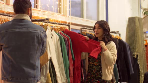 Couple Choosing Clothes at Vintage Clothing Store 7