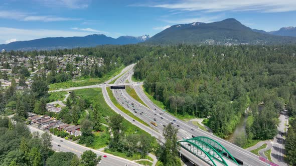 Traffic At Trans-Canada Highway With Verdant Trees In Lynnmour, North Vancouver, BC, Canada. - aeria