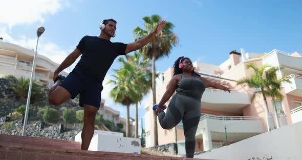 Curvy african woman doing sport workout with personal trainer outdoor