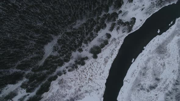 Aerial view of winter river near the forest and fields, Mainly cloudy