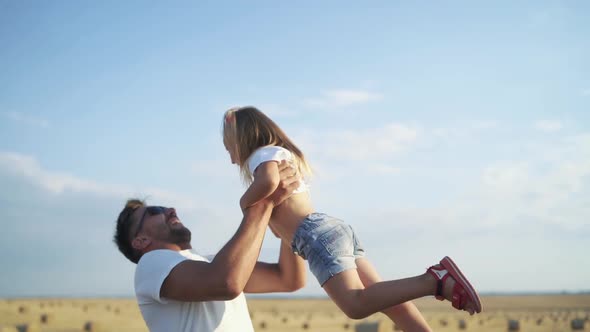 Happy Father in Sunglasses Throws Up His Lovely Daughter on Hands