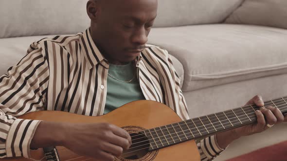 Good-looking African-American Man Playing Guitar at Home