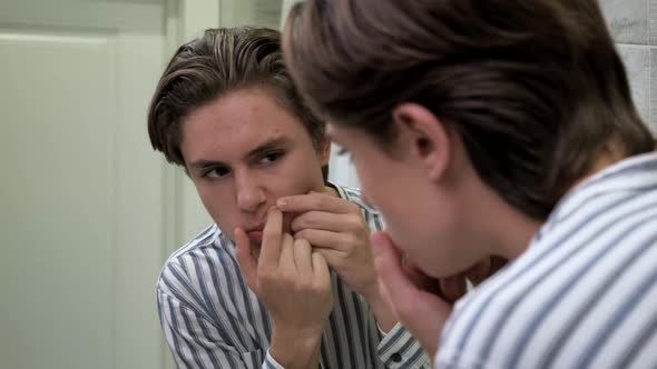 Young Guy Crushes Pimples in the Bathroom