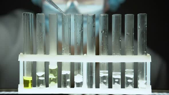 Chemist Pouring Liquid Bubbling Substance in Test Tube, Secret Laboratory