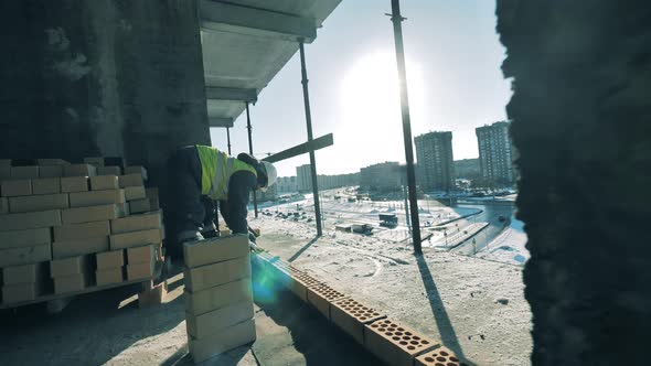 Workers Are Doing Masonry on a Building in Progress