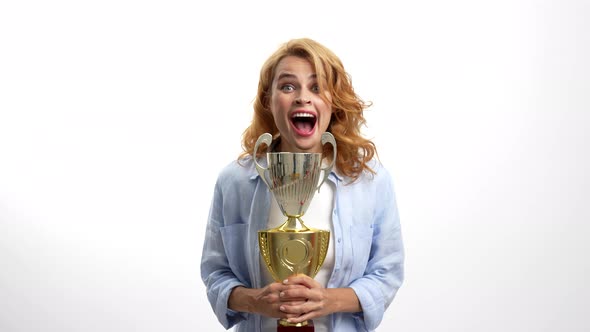 Surprised Happy Girl Celebrate Success with Championship Cup Achievement Award