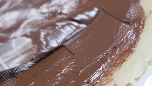 Hazelnut creme spread over pancake  texture  close-up 4K 2160p 30fps UltraHD tilting footage - Choco