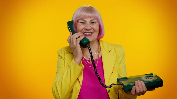 Senior Stylish Granny Woman Talking on Wired Vintage Telephone of 80s Says Hey you Call Me Back