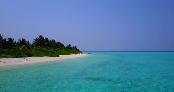 Daytime fly over clean view of a white sand paradise beach and aqua blue ocean background in high re